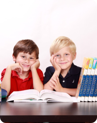 Two students smiling with a book open